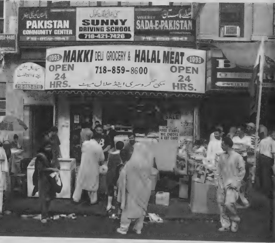 Photograph of storefronts and community signs in a Pakistani neighborhood near Newkirk Avenue, Brooklyn, New York, 2005.
